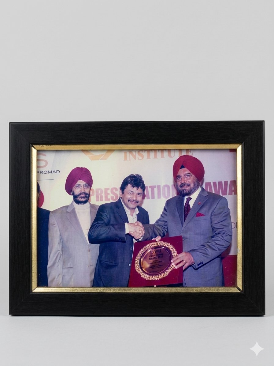 Framed photograph of Rejesh Satiija receiving a presentation award in 2011